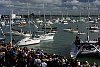 America's Cup 2003: A huge spectator fleet farewells Team New Zealand and Alinghi Swiss Challenge as they head to the racecourse on the first day of competition.