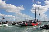 America's Cup 2003: A huge spectator fleet farewells Team New Zealand and Alinghi Swiss Challenge as they head to the racecourse on the first day of competition.