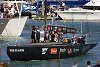 America's Cup 2003: A huge spectator fleet farewells Team New Zealand and Alinghi Swiss Challenge as they head to the racecourse on the first day of competition.