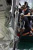 America's Cup Race 4: Crew continues to remove the main.