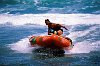 A surf rescue boat speeds in to the beach/ New Zealand